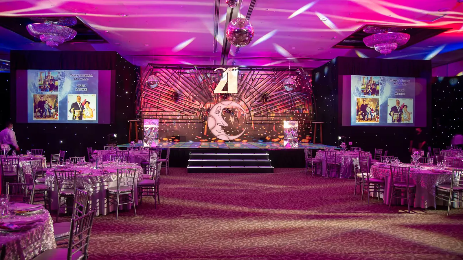 Vibrant event hall set up for a themed dinner with elegant decorations and lighting.